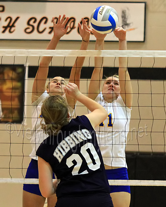 Amanda Bisel and Amanda Belden team up for a block on Hibbing's Kailey Wirtanen
