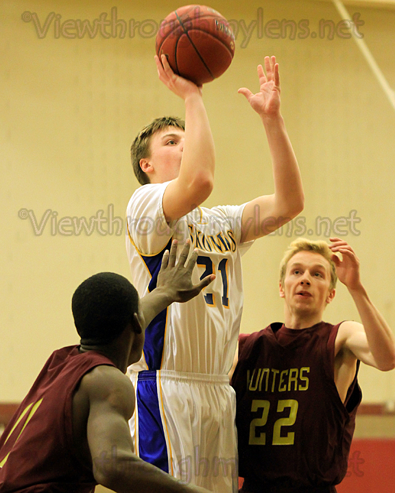Casey Staniger puts up a shot in the lane, between two Denfeld players.