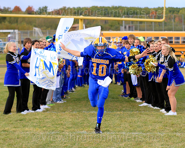QB Marc Peterson breaks the homecoming banner