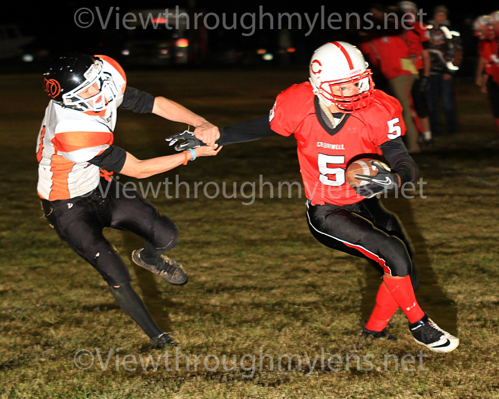 Joe Couture tries to escape the grasp of a Wrenshall tackler on his 8 yard touchdown run Wednesday night.