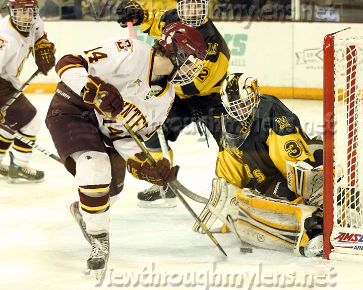 Marshall goaltender Caden Flaherty stops a Ried Lemker shot in the crease in the 7A Final.