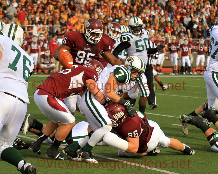 Chris Vandervest (#96) and Blake Rogers team to force a fumble by Bemidji State’s Justin Lee