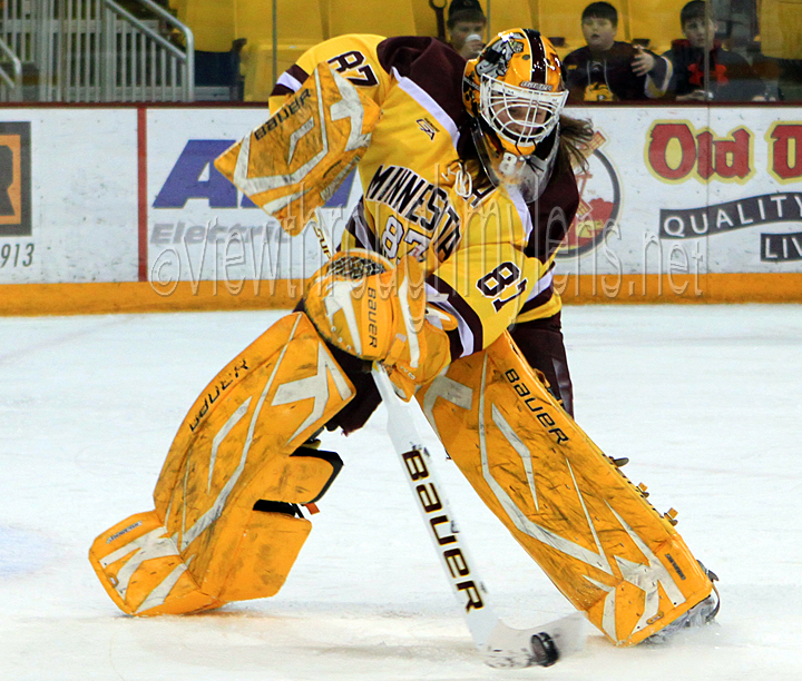 UMD Goaltender Jenny Harss plays the puck vs Ohio State